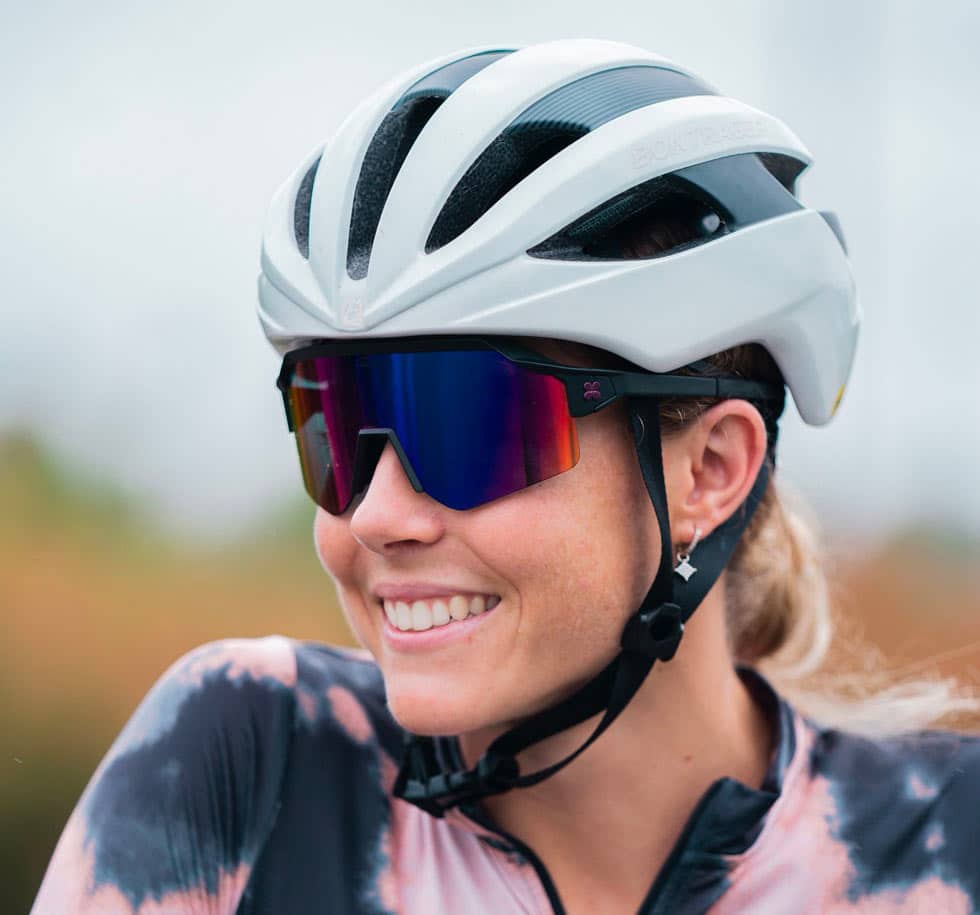 A woman wearing Sungod glasses for cycling with coloured Lenses 