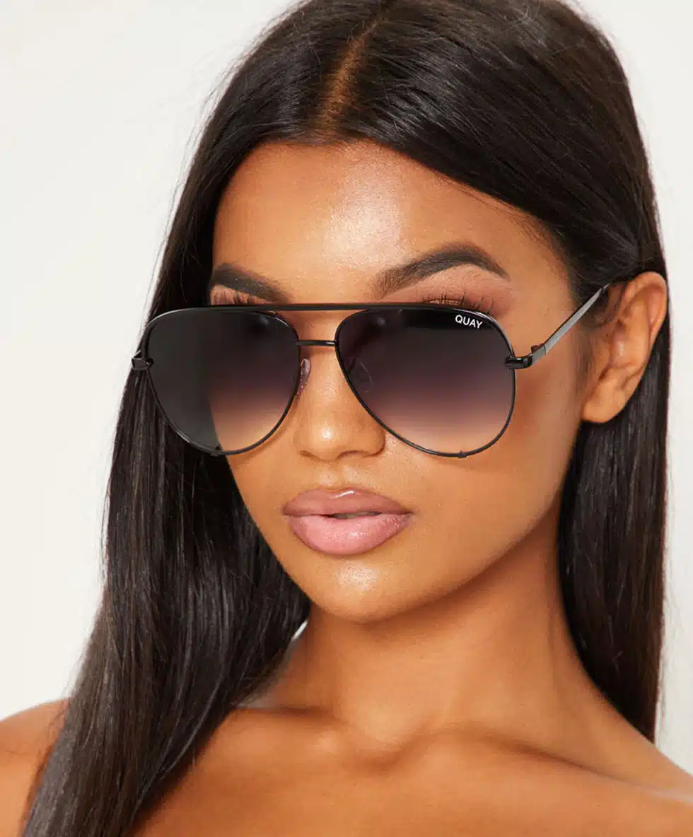 Woman wearing Quay Australia sunglasses with a gradient tint