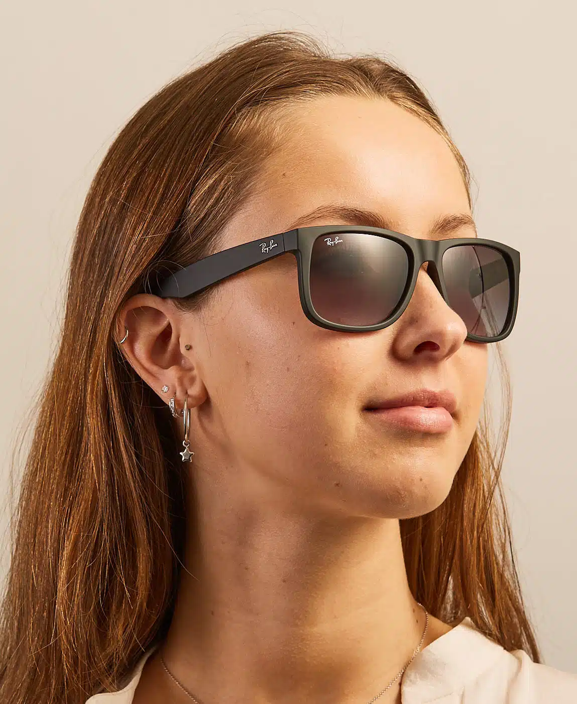 woman wearing Ray-Ban Justins with dark lenses