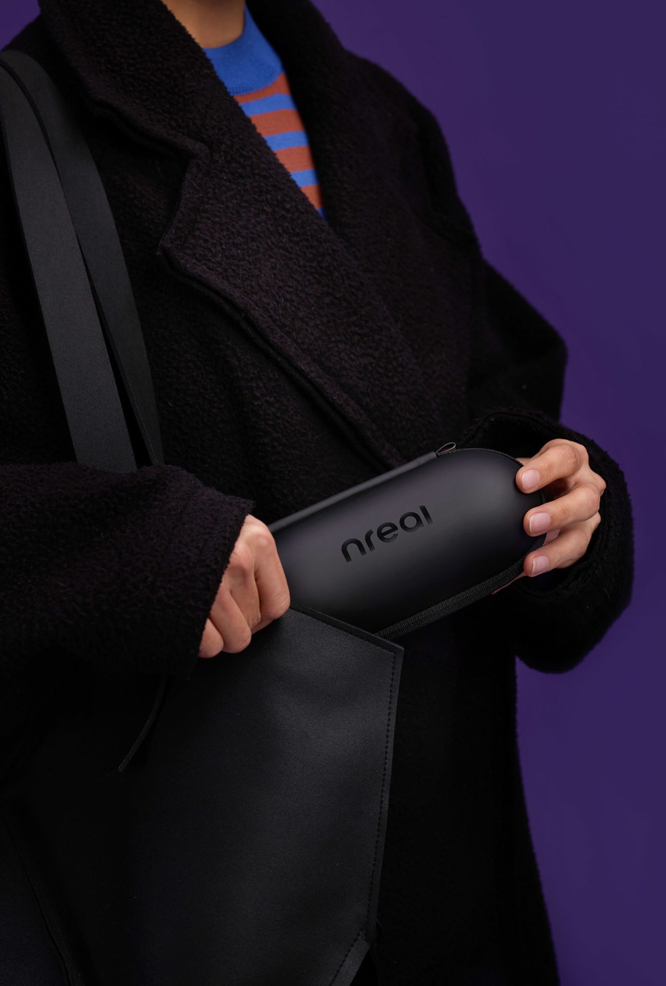 person holding Xreal / Nreal Air glasses case