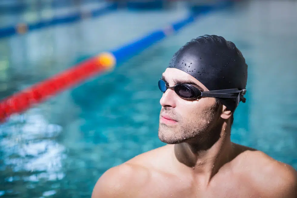 a swimmer in a pool wearing prescription swimming goggles