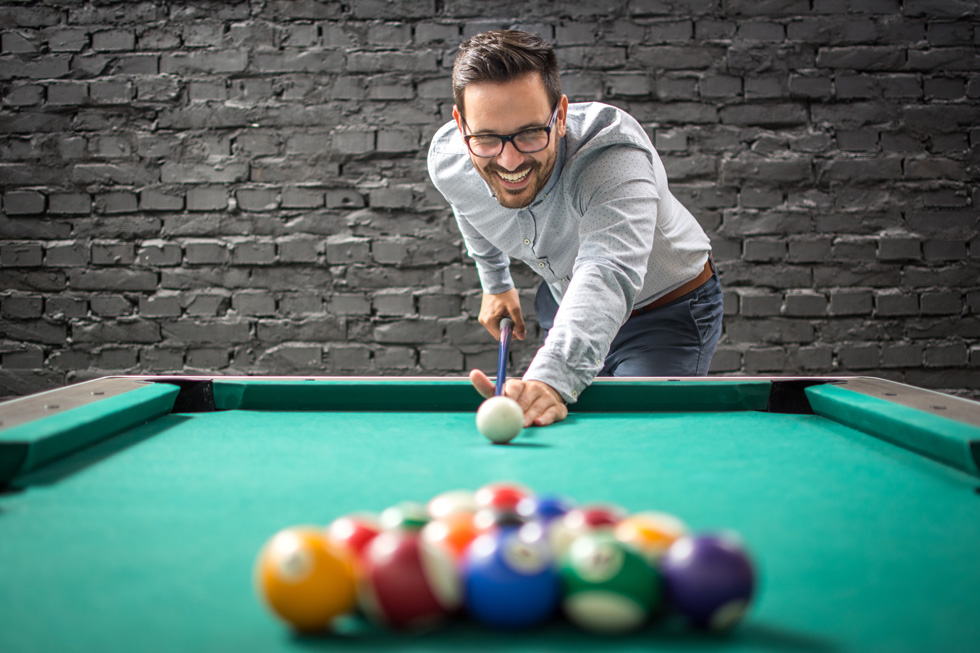 a person playing pool wearing a pair of prescription snooker glasses