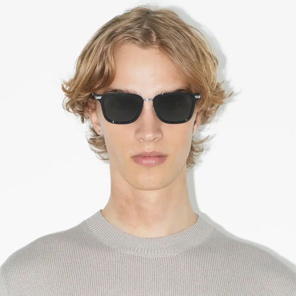 a person wearing glasses with Burberry replacement lenses