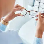 A person using a tape measure as a glasses measurement guide