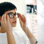 A woman trying on a pair of glasses from the opticians