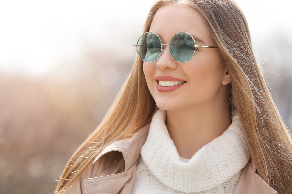 A woman wearing Transitions® XTRActive® lenses