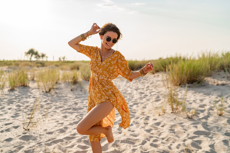 A woman on the beach wearing glasses with transitions lenses