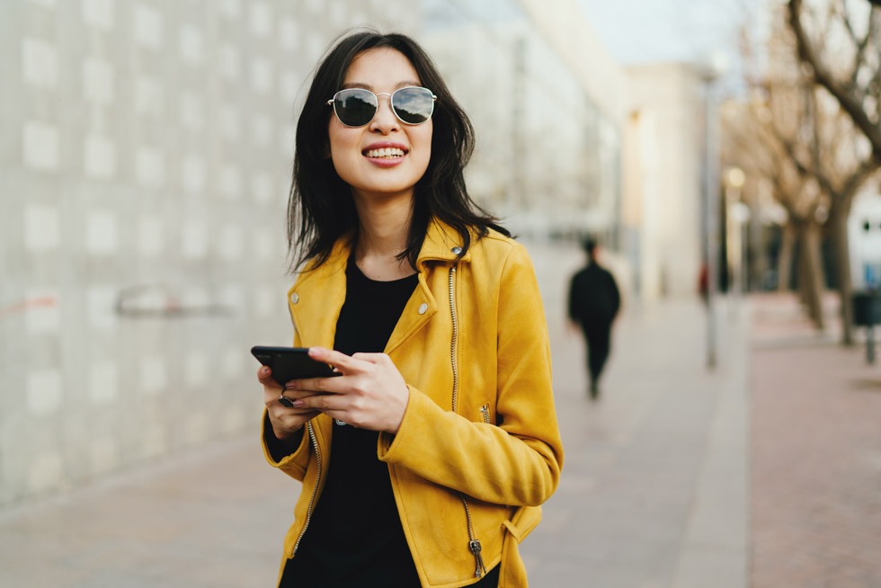 A woman wearing Transitions® gen s lenses in her glasses