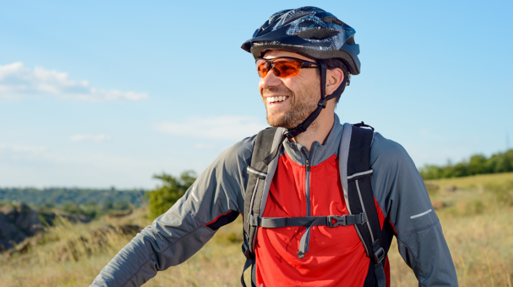 Portrait of Young Cyclist in Helmet and Glasses