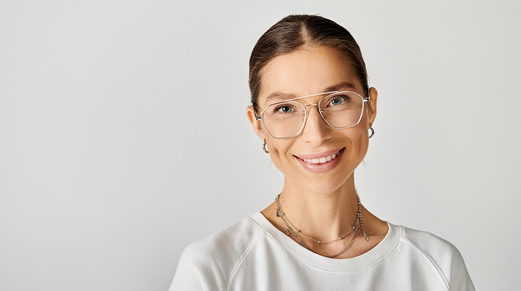 Cheerful female wearing glasses smiling at camera