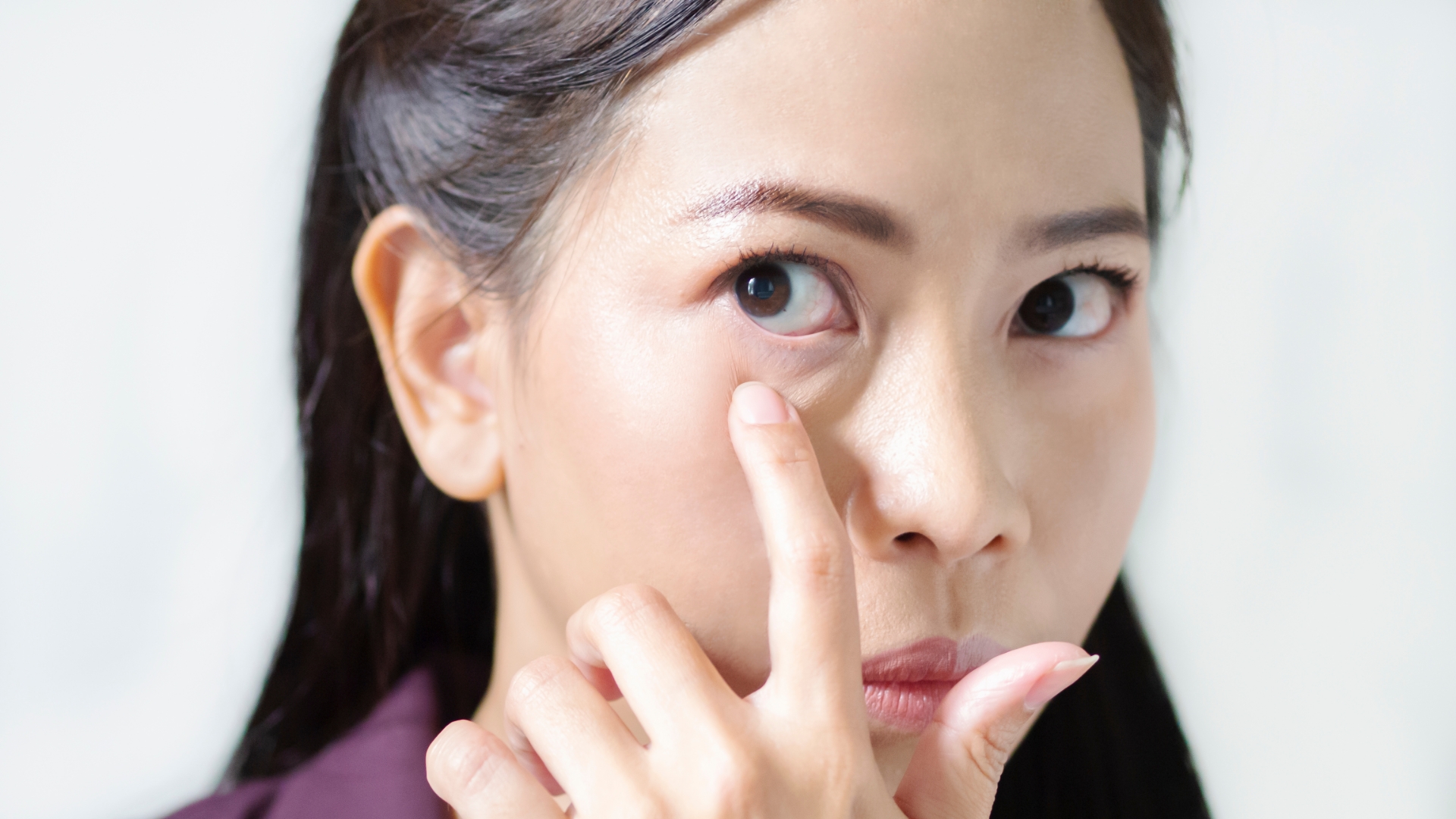 woman looking at her eye