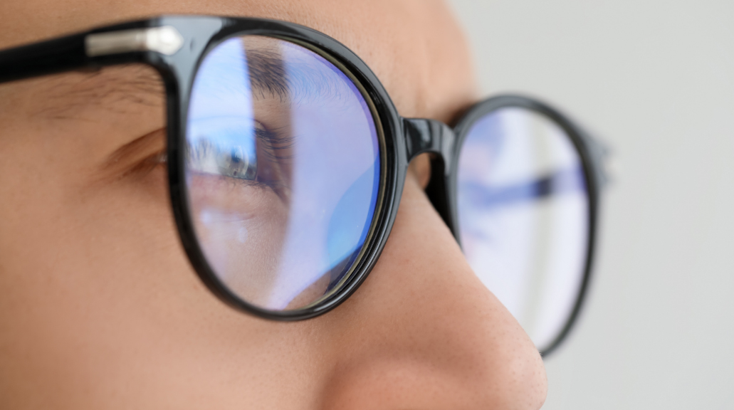 Close up of man wearing glasses on blurred background