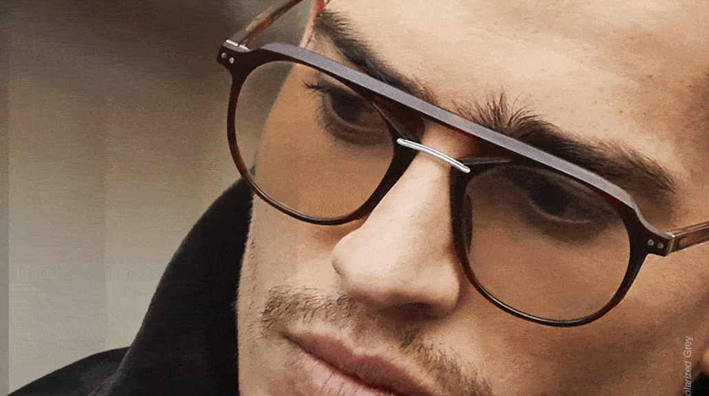 Close up of man wearing glasses on blurred background