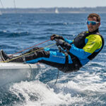 Man sailing boat wearing sports glasses