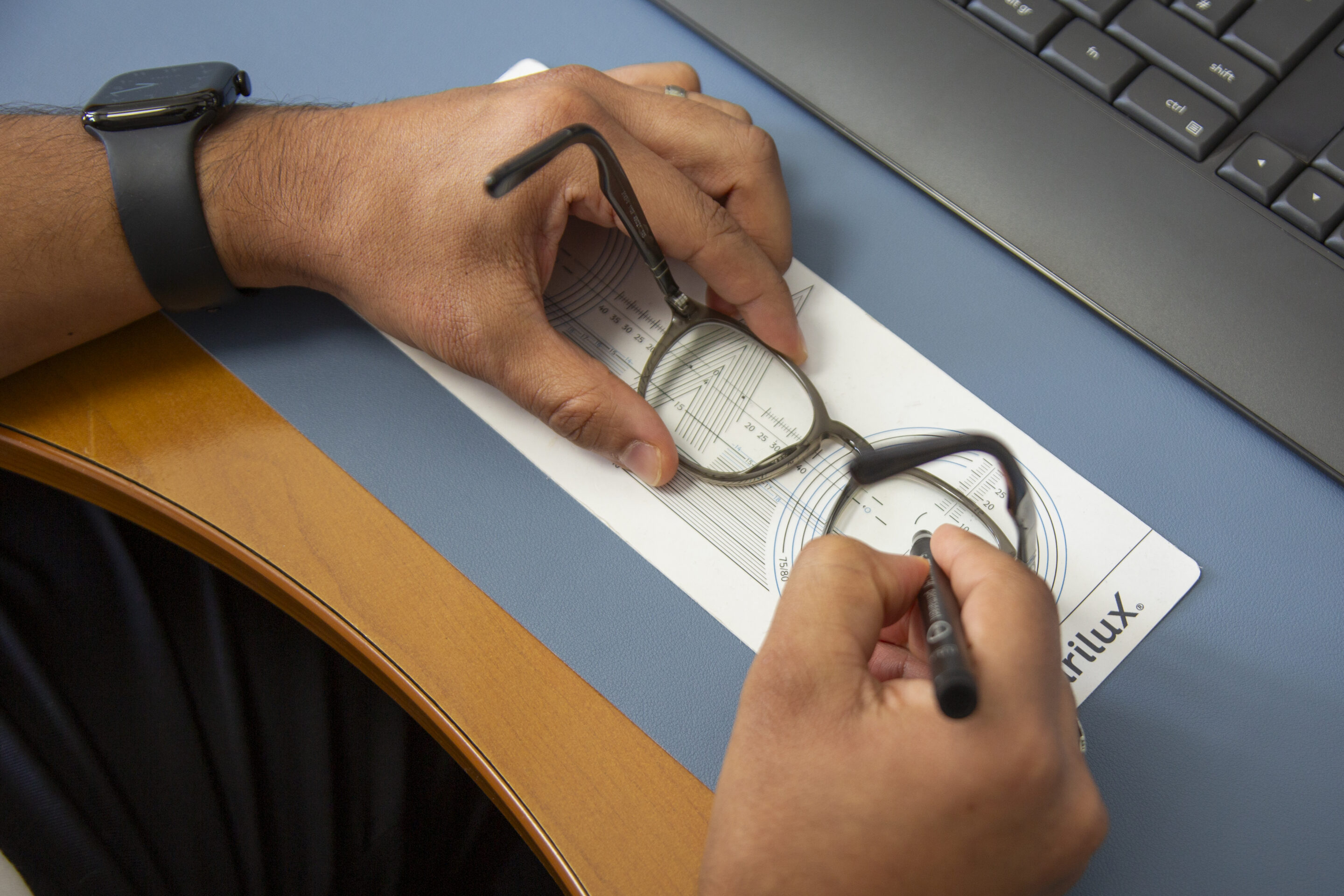 Dotting up a lens at the Lensology lab, showing how prescription lenses measured online are prepared for glazing