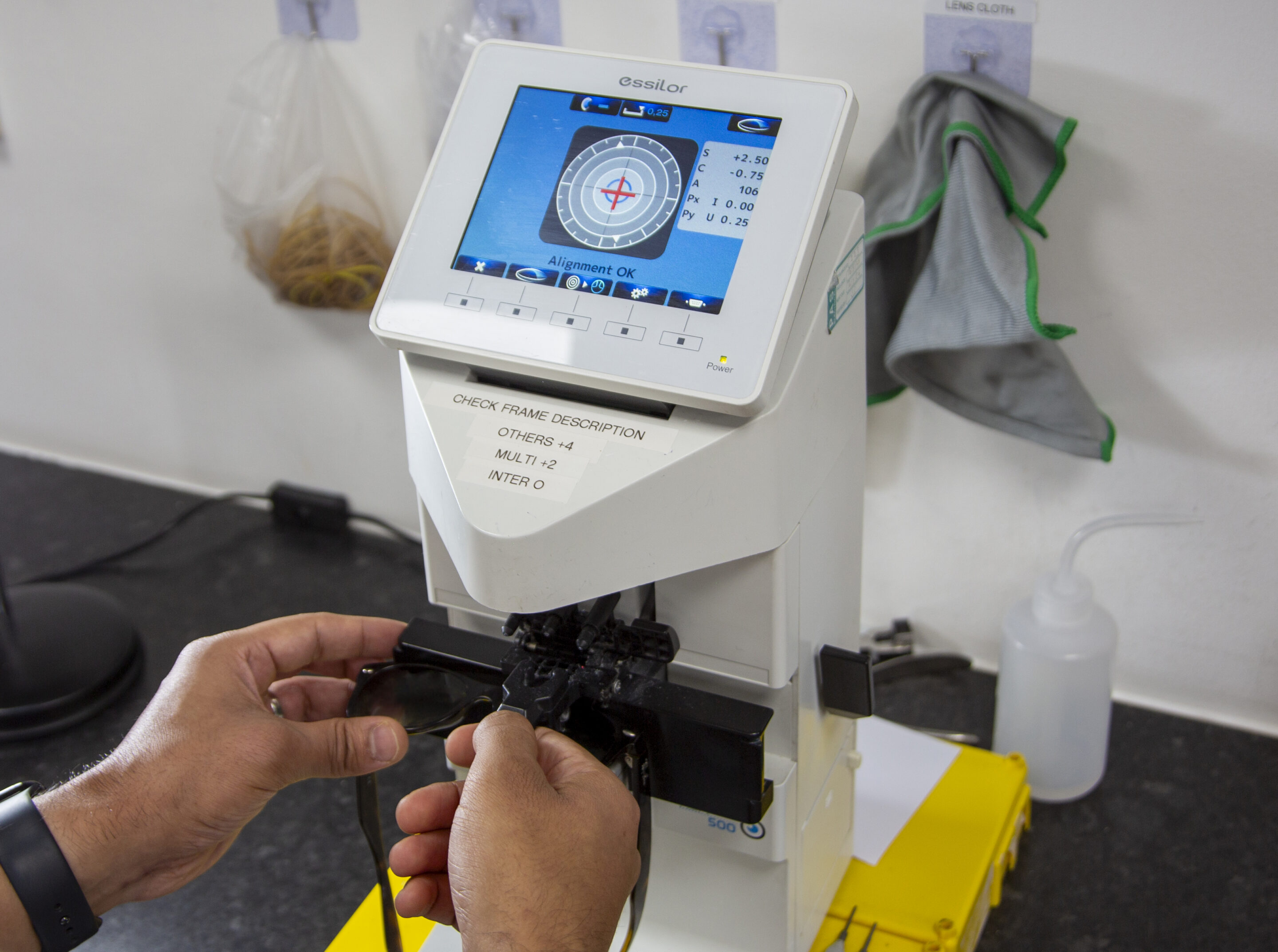 A focimeter being used to verify a lens prescription before the glasses are dispatched
