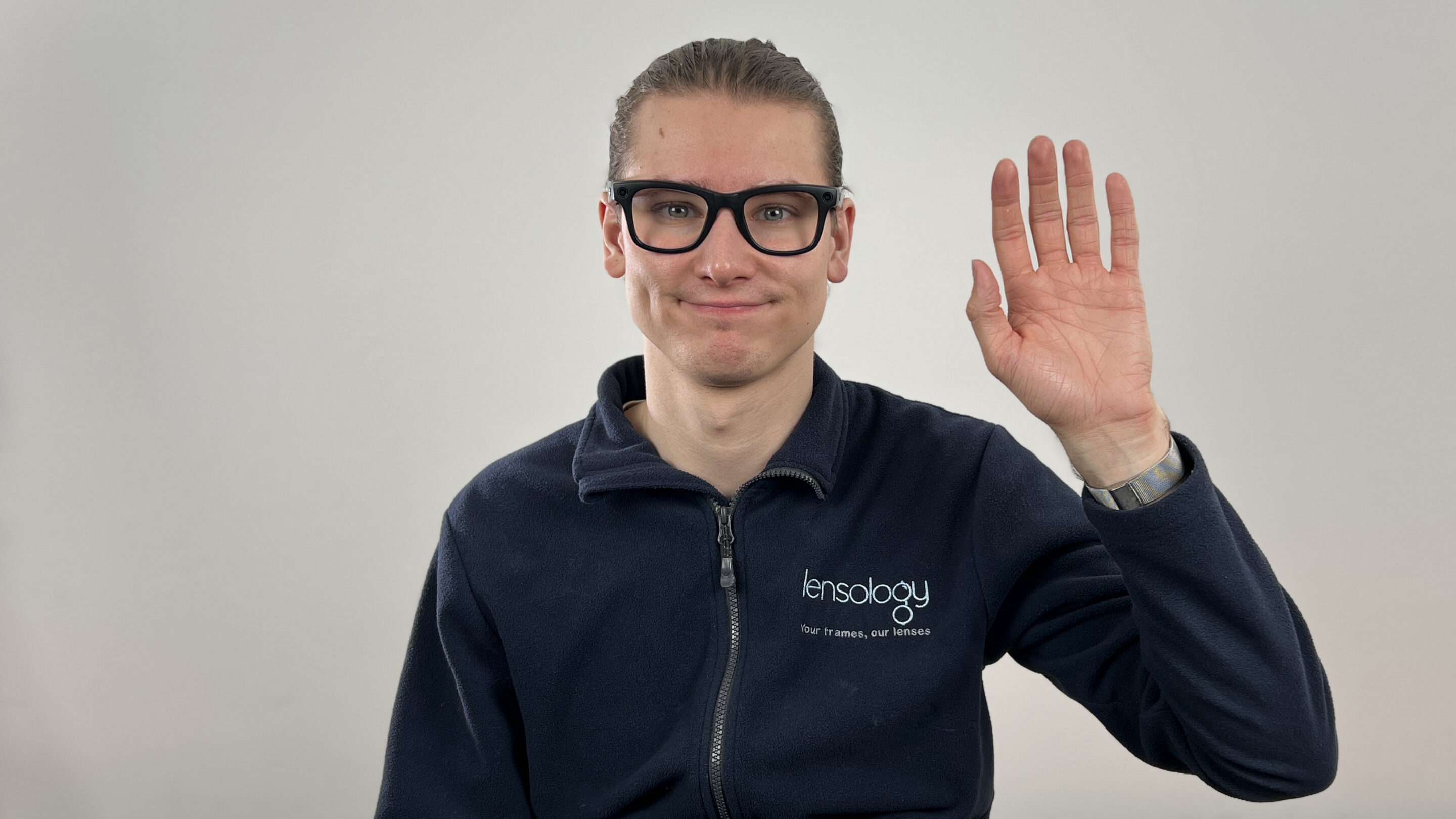 Pupillary distance being measured on a pair of Meta smart glasses held in the hand