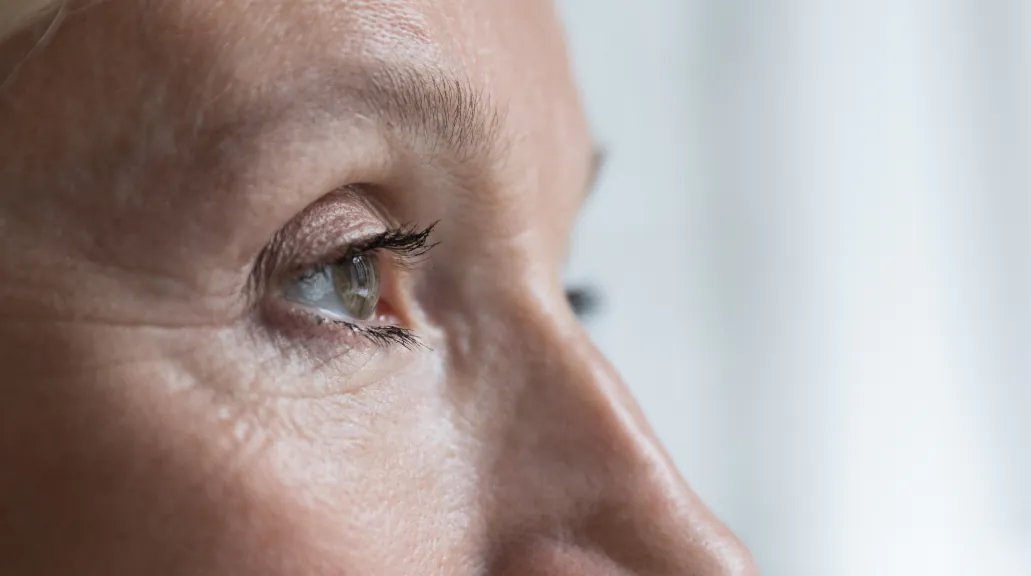 Close up cropped shot, face of senior woman eye looking straight, into distance
