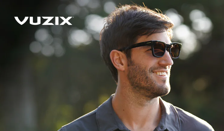 Man wearing Vuzix Z100 smart glasses outside