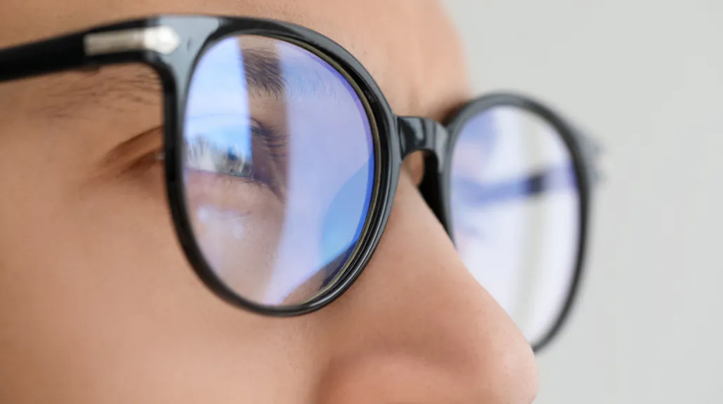 Close up of man wearing glasses on blurred background